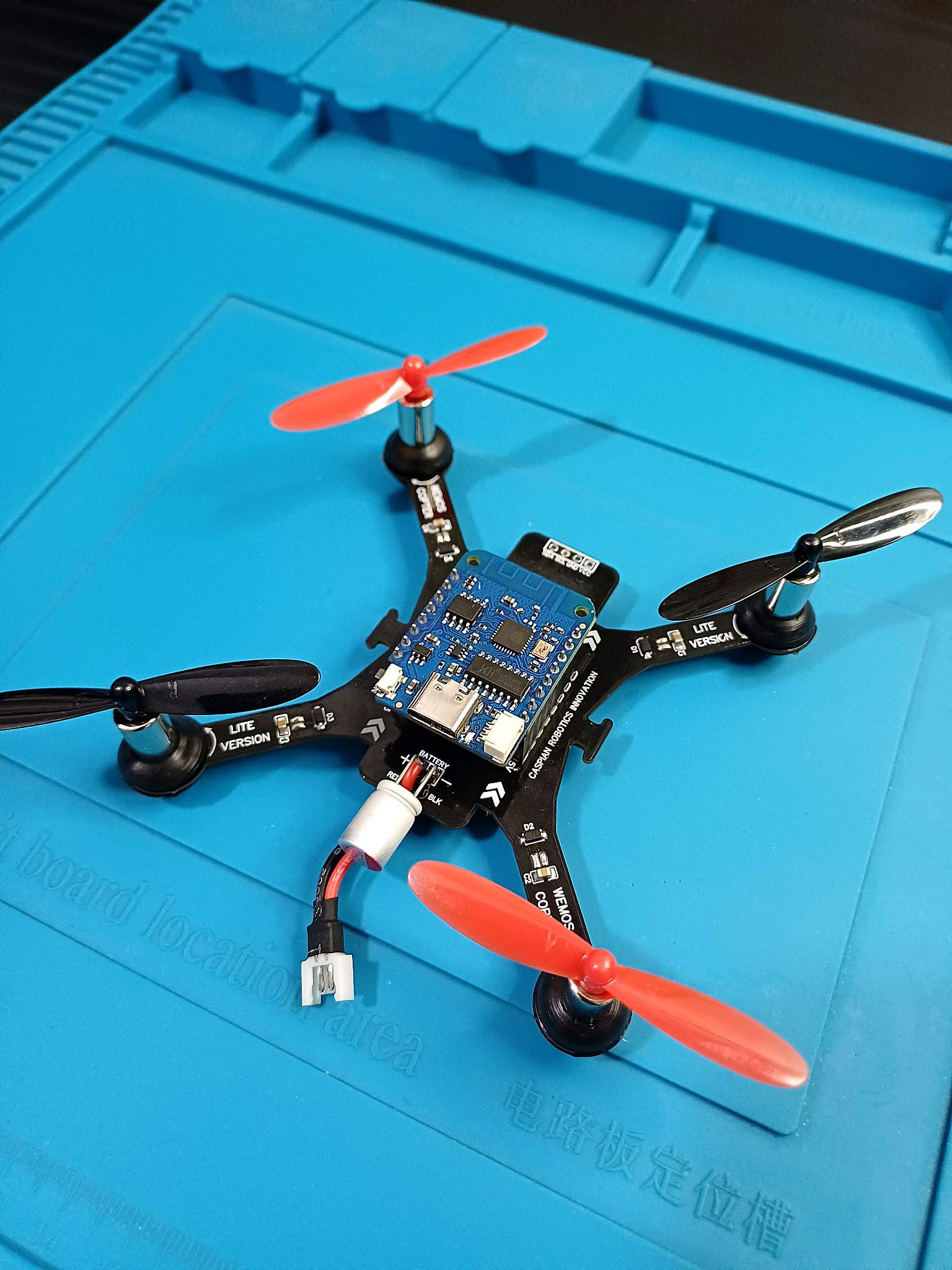 Real ESPFlight quadcopter prototype built on a maker workbench